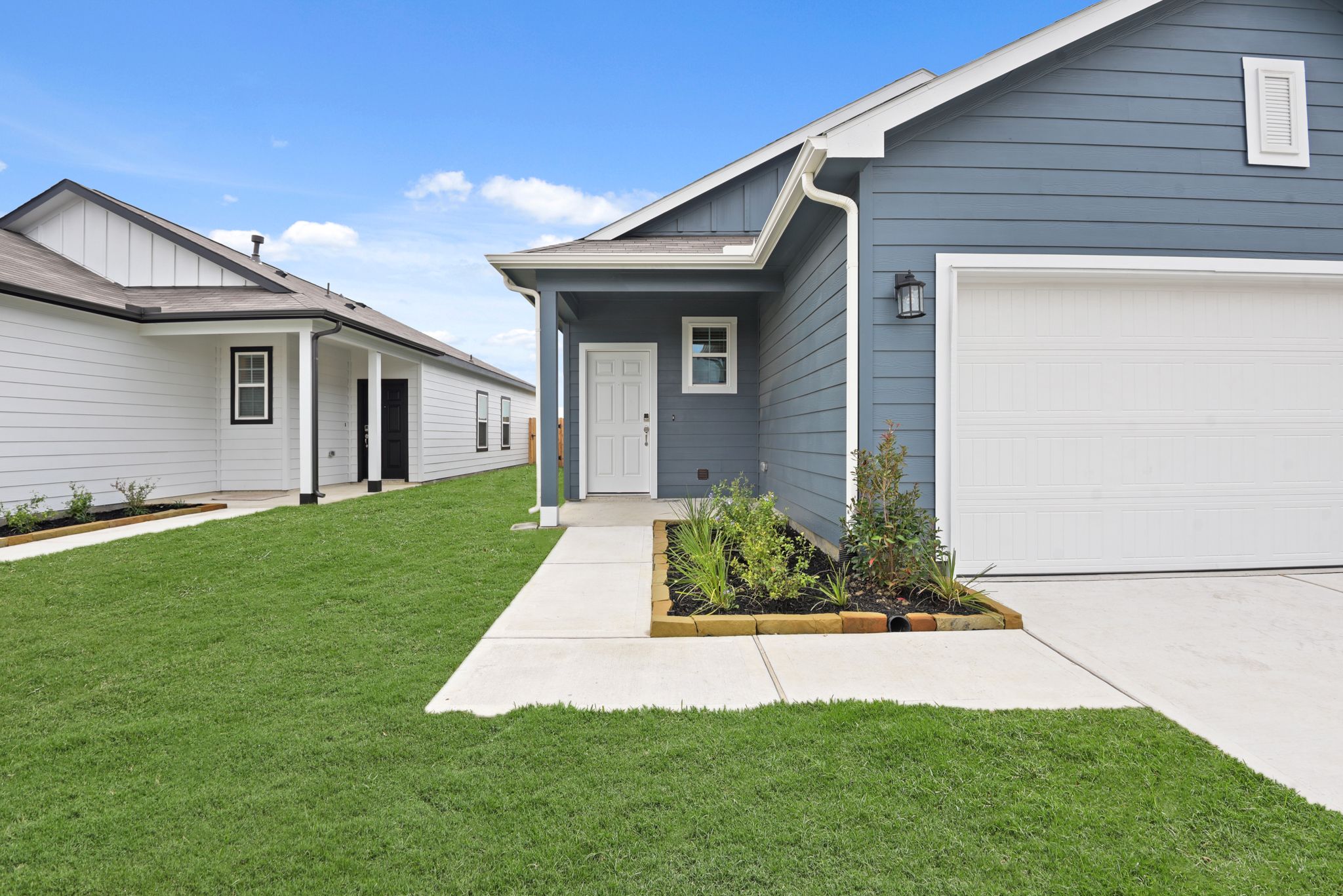 A house with a green lawn.