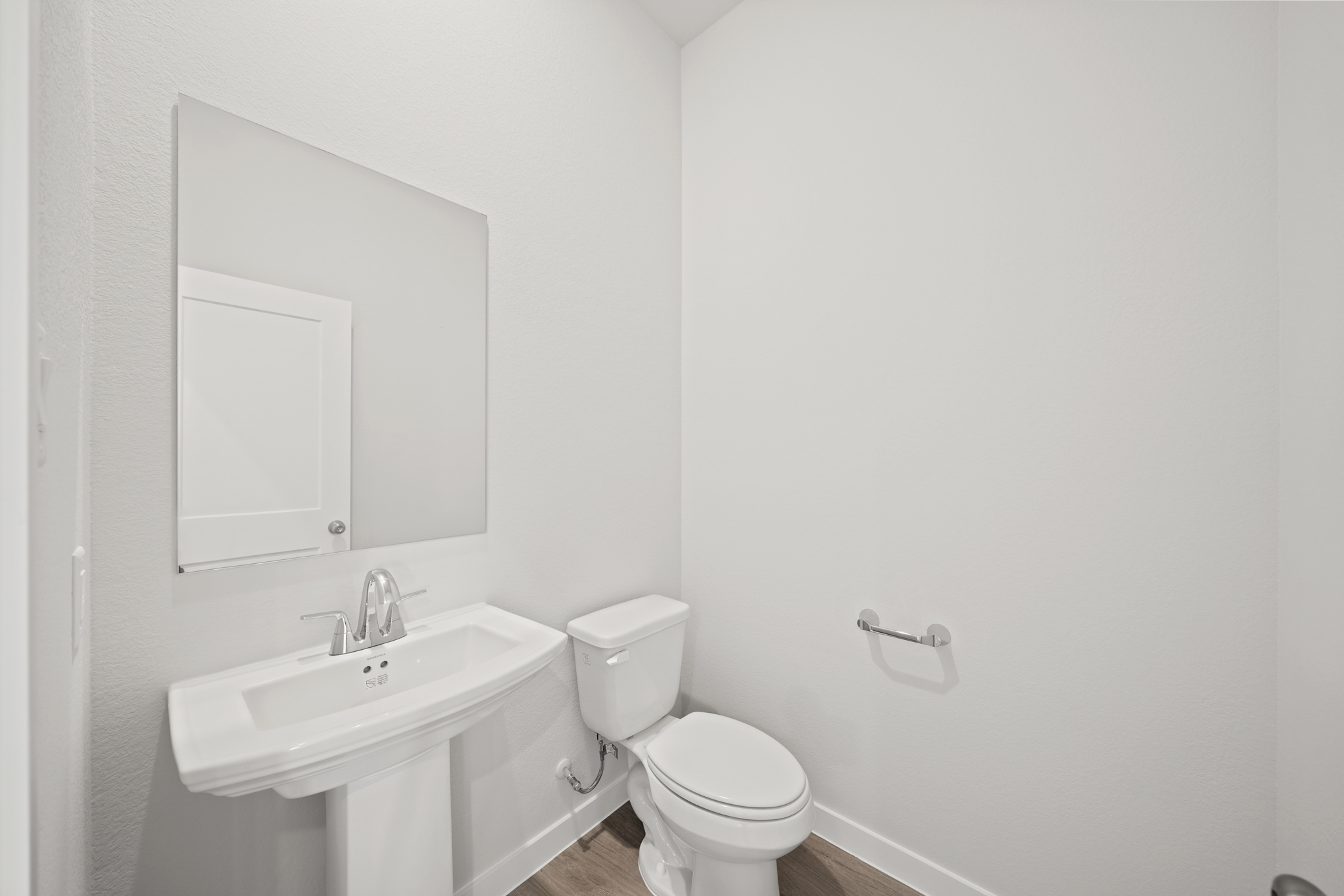 A bathroom with a toilet and sink.