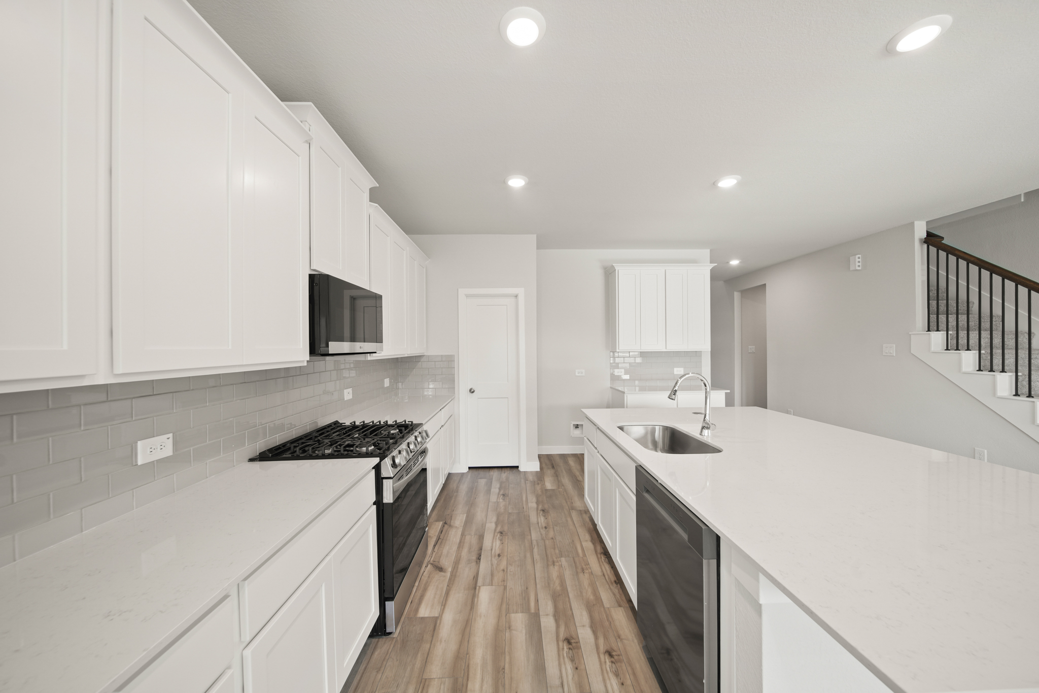 A kitchen with white cabinets.