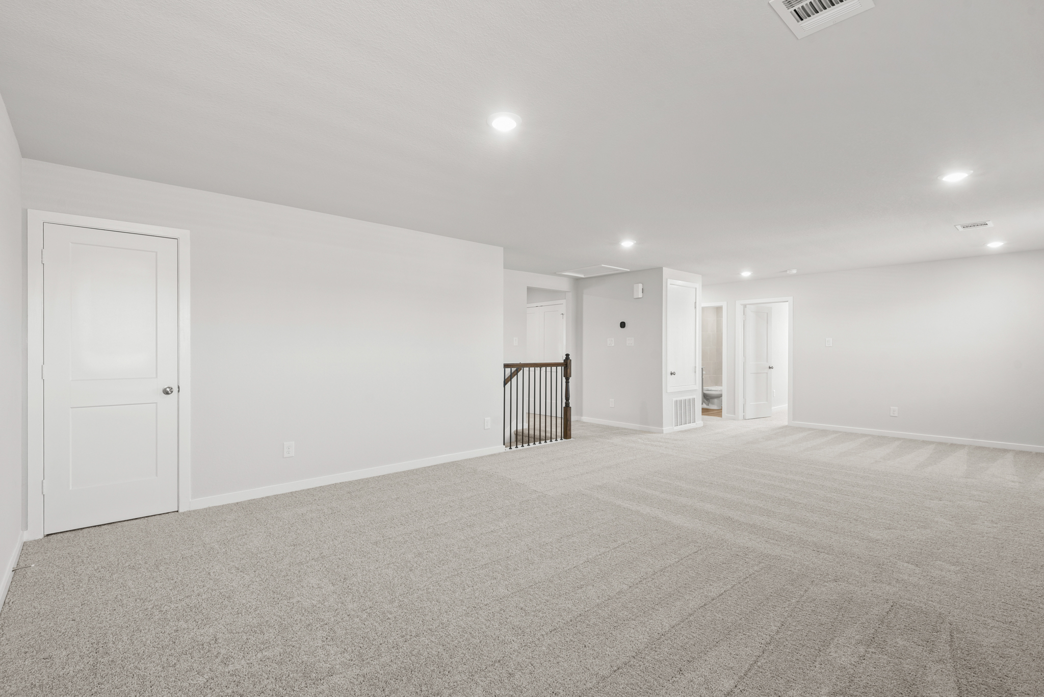 A large empty room with white doors.