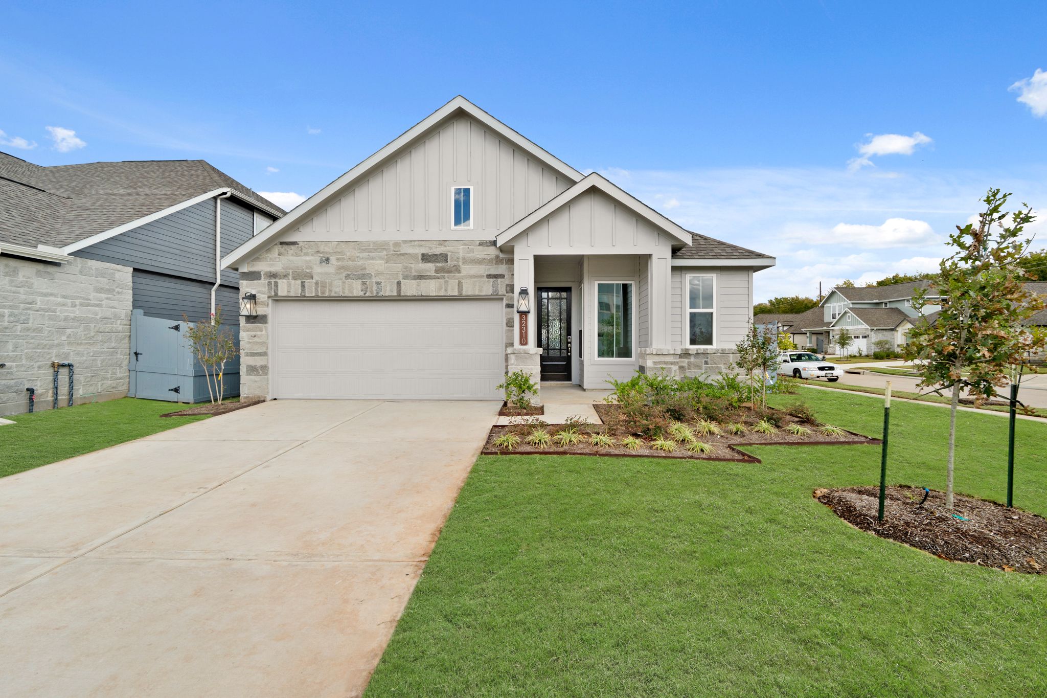 A house with a driveway with Southfork Ranch in the background.