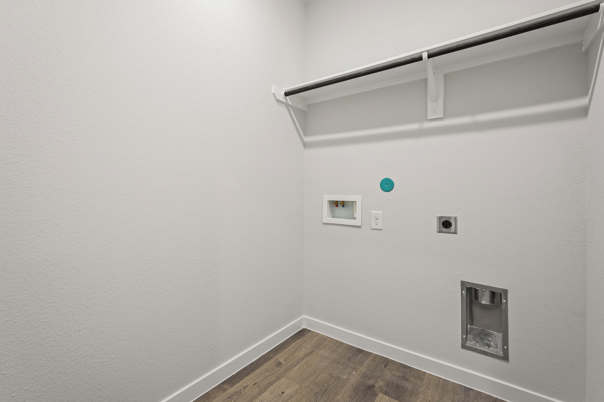 A white wall with a light fixture.