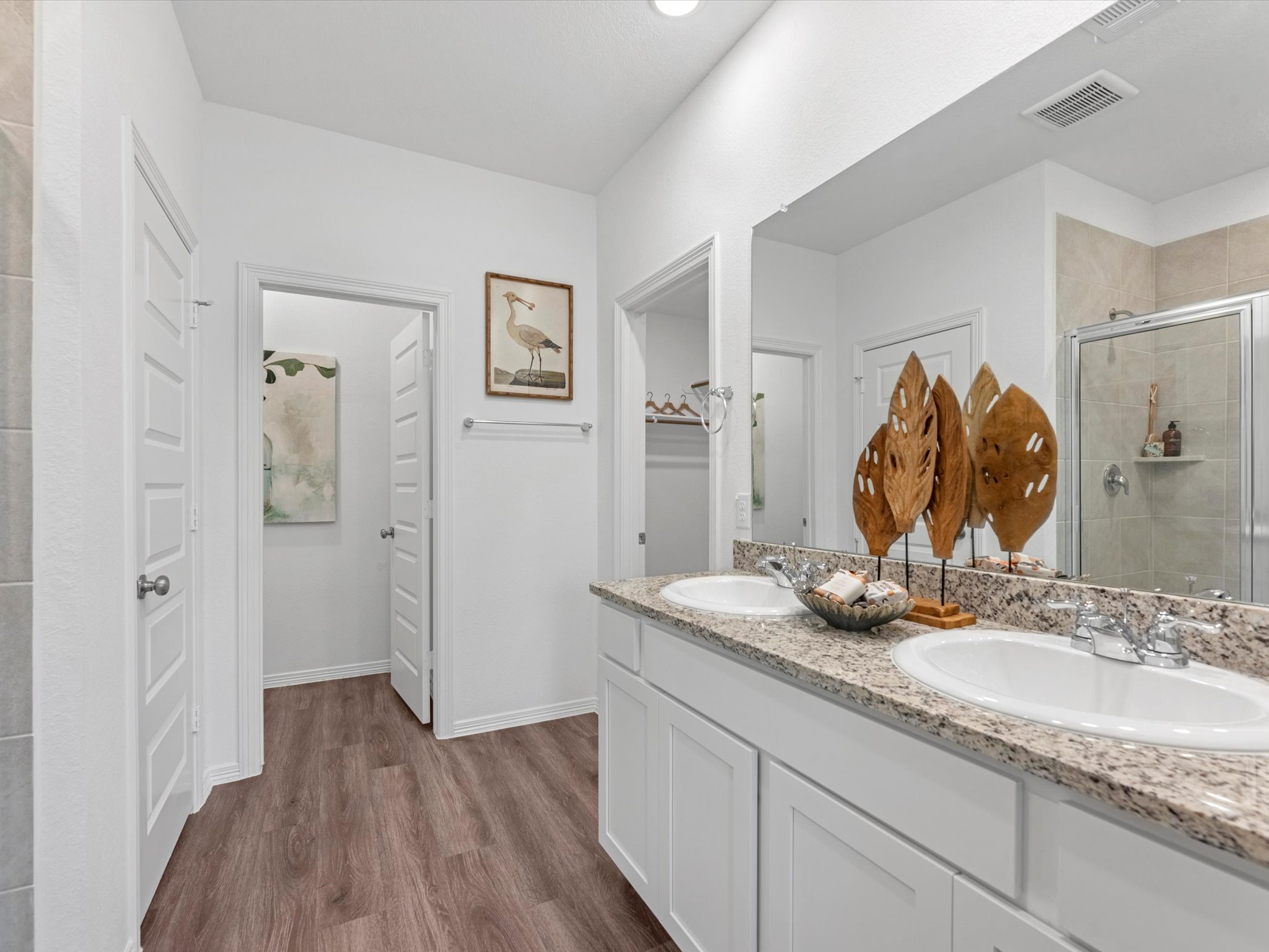 A bathroom with a large mirror.