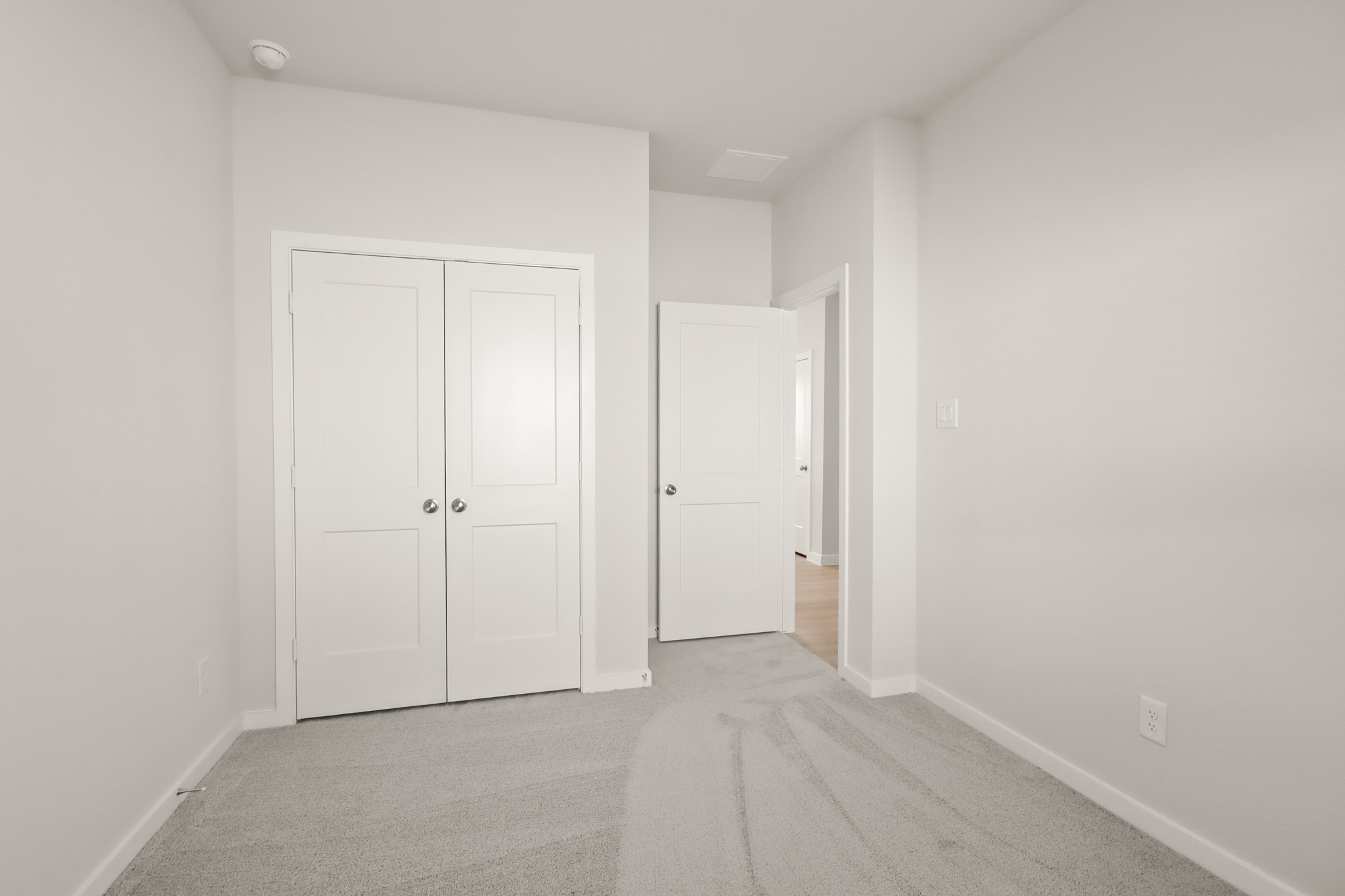 A hallway with white doors.