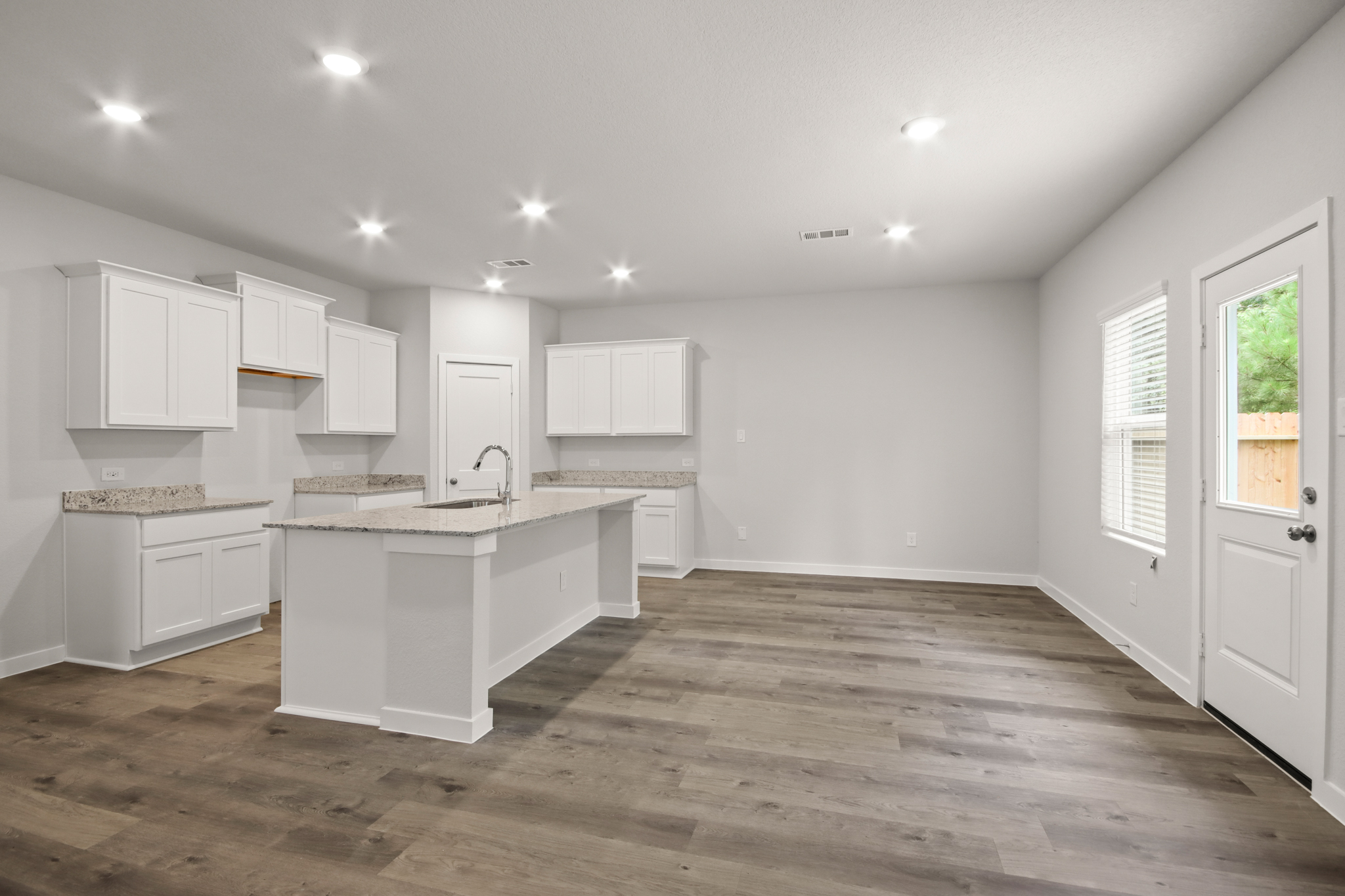 A kitchen with white cabinets.