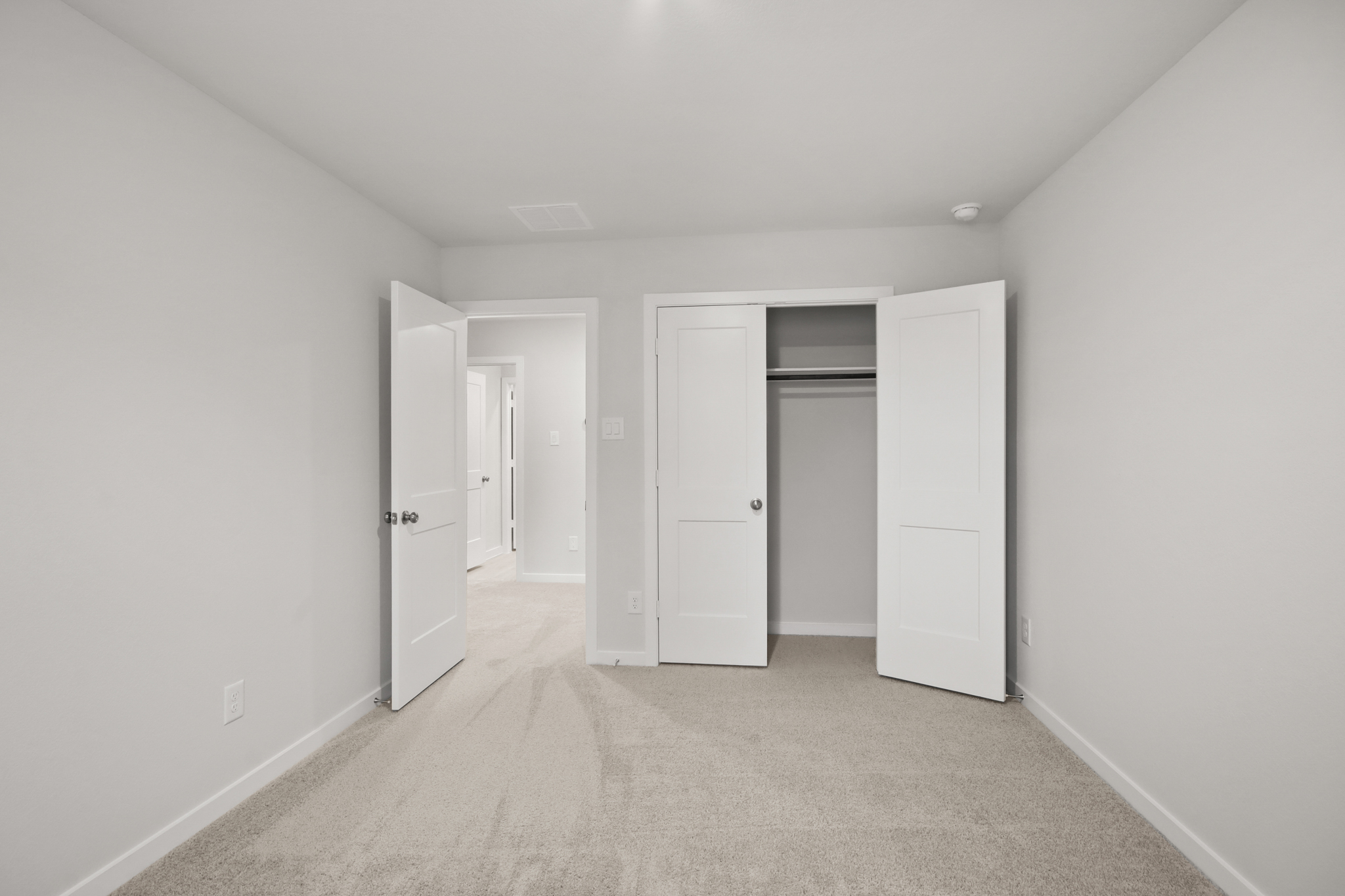 A hallway with white doors.