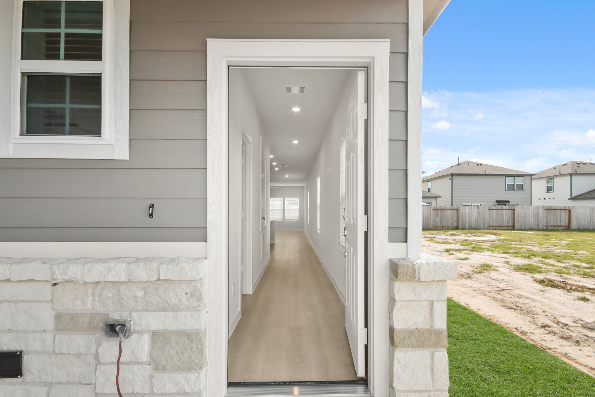 A white house with a walkway.