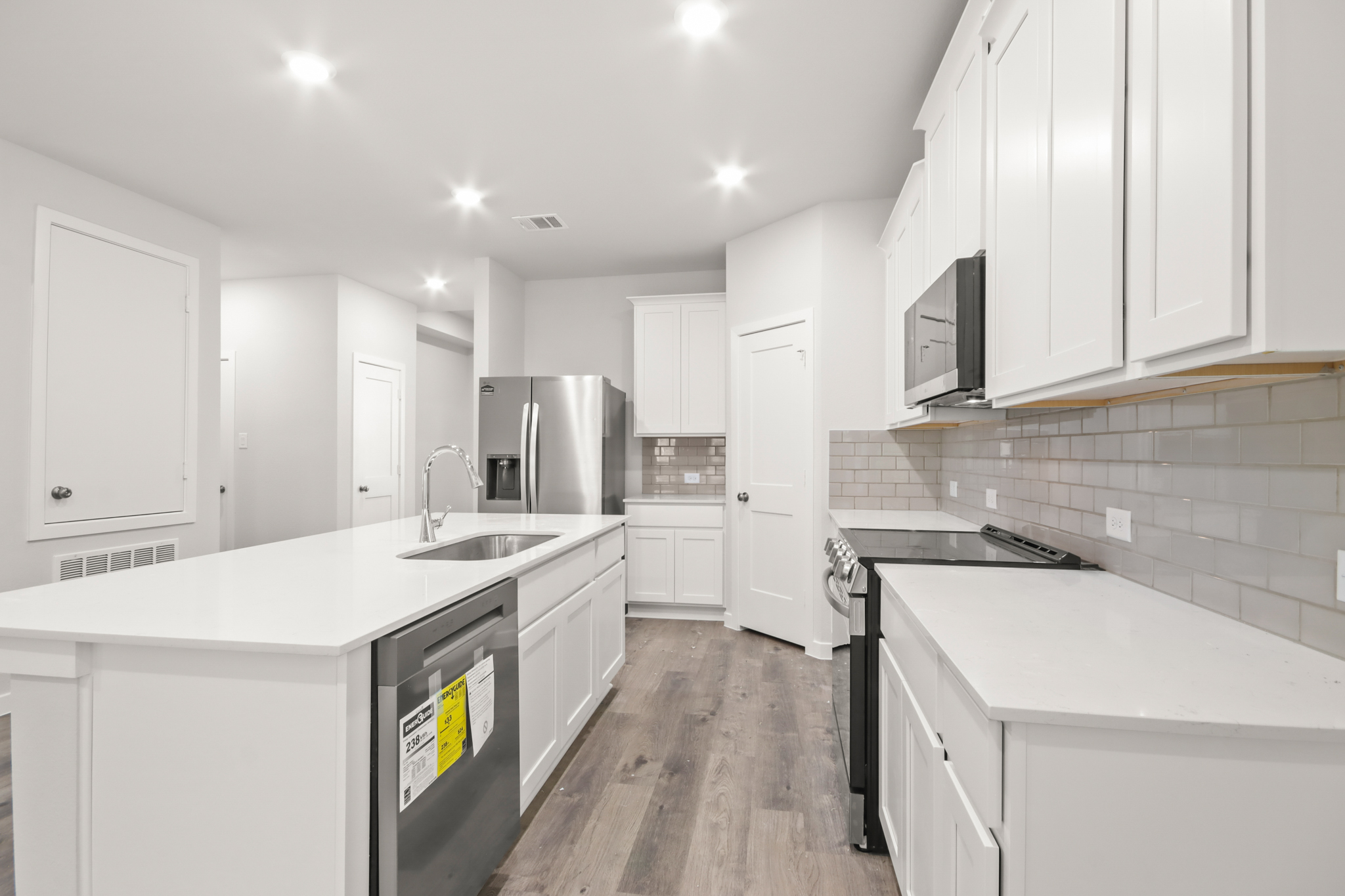 A kitchen with white cabinets.