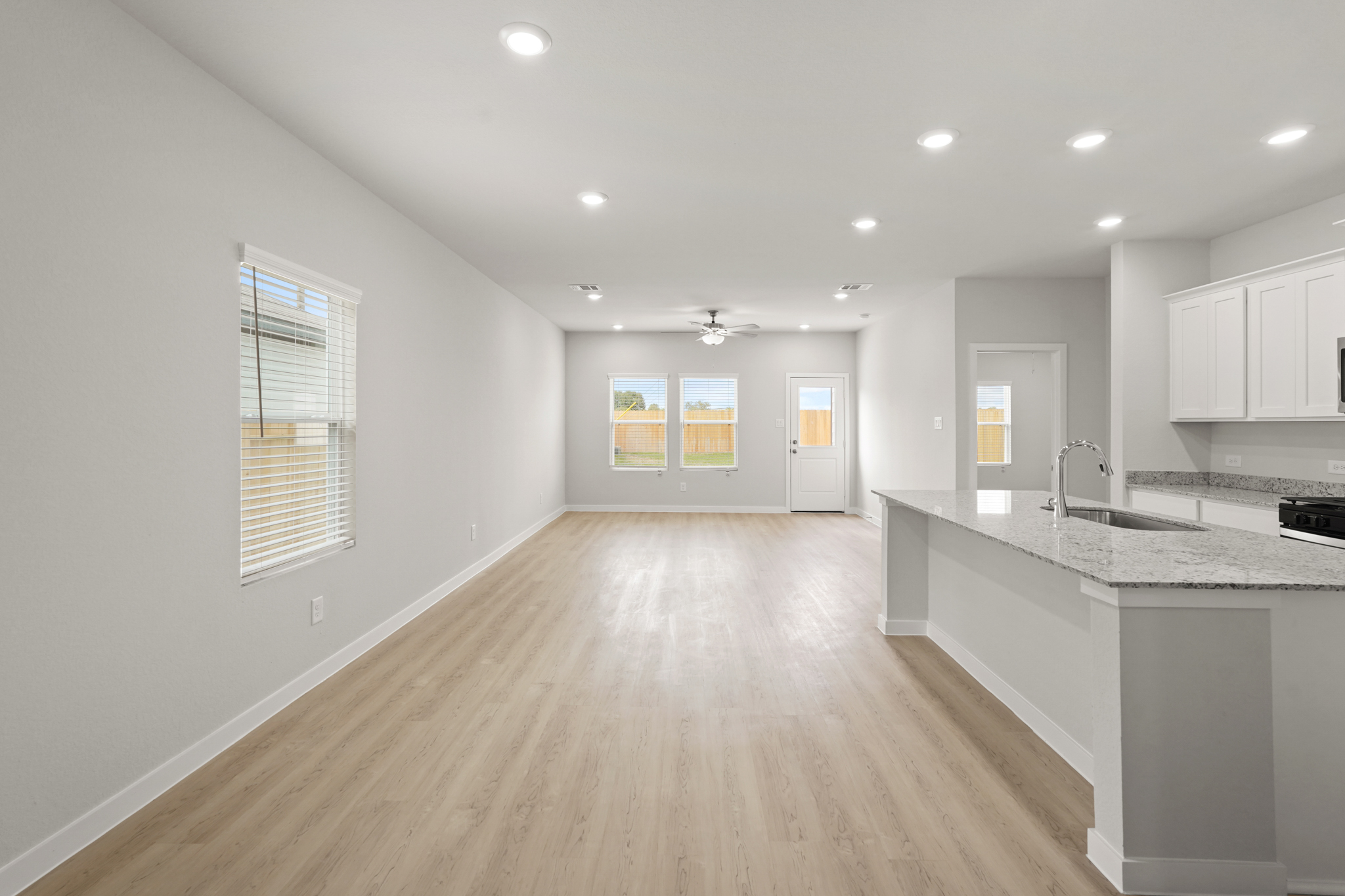 A kitchen with white cabinets.