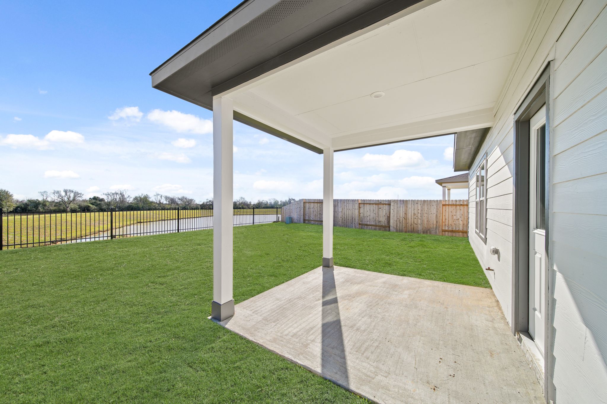 A house with a fence and grass.