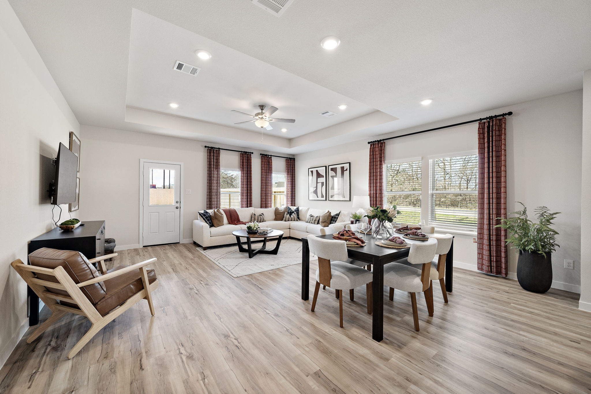 A large living room with a large dining table and chairs.