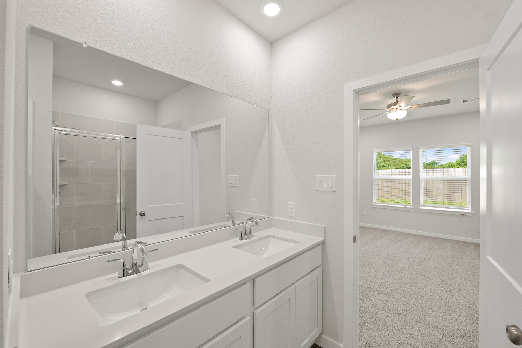 A bathroom with a large mirror.