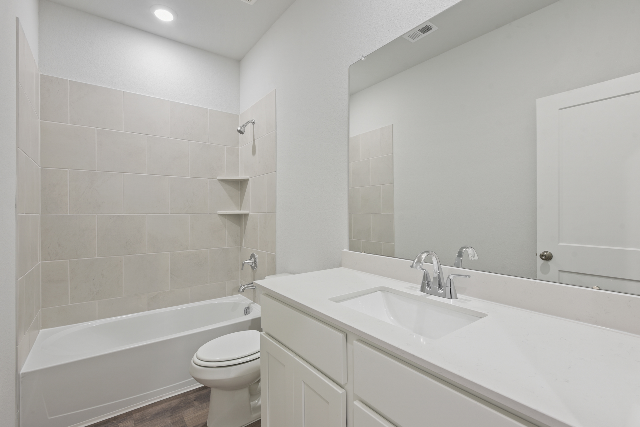A bathroom with a tub sink and toilet.
