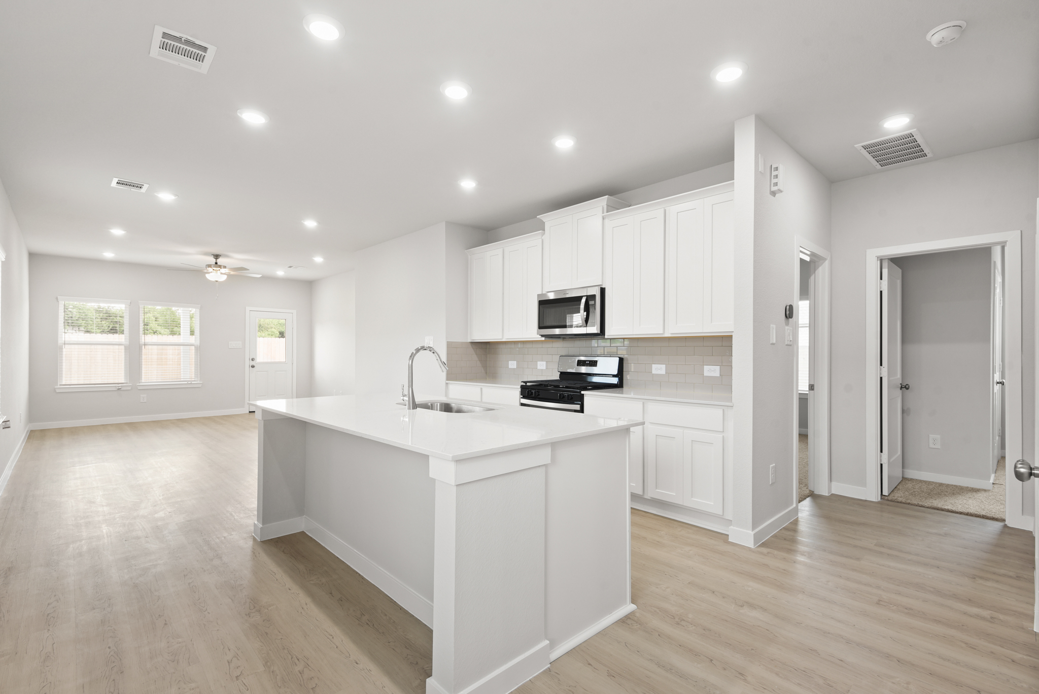 A kitchen with white cabinets.
