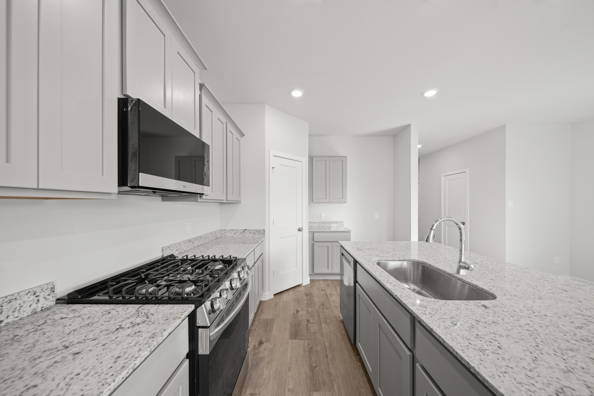 A kitchen with white cabinets.
