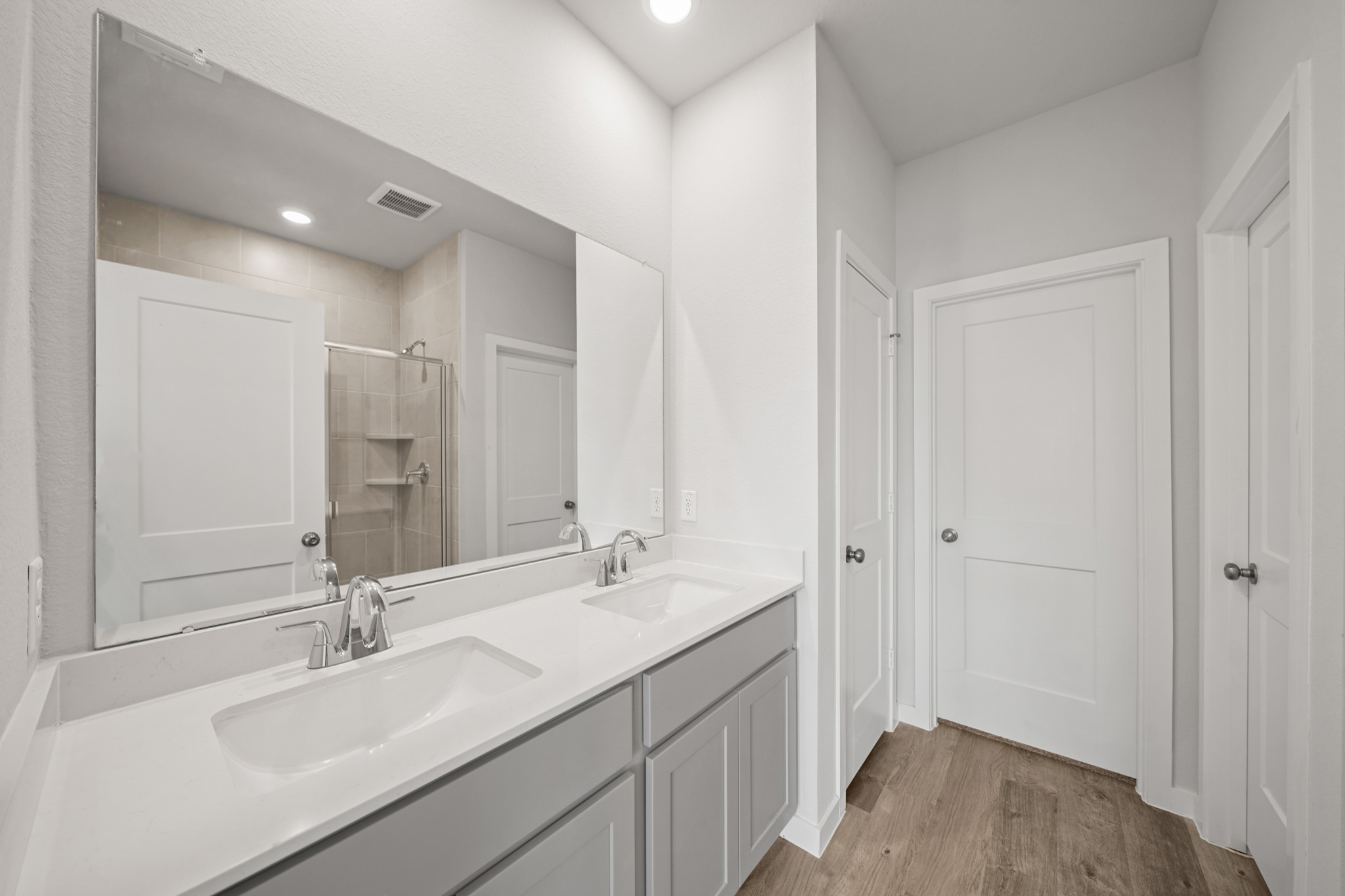A bathroom with a large mirror.