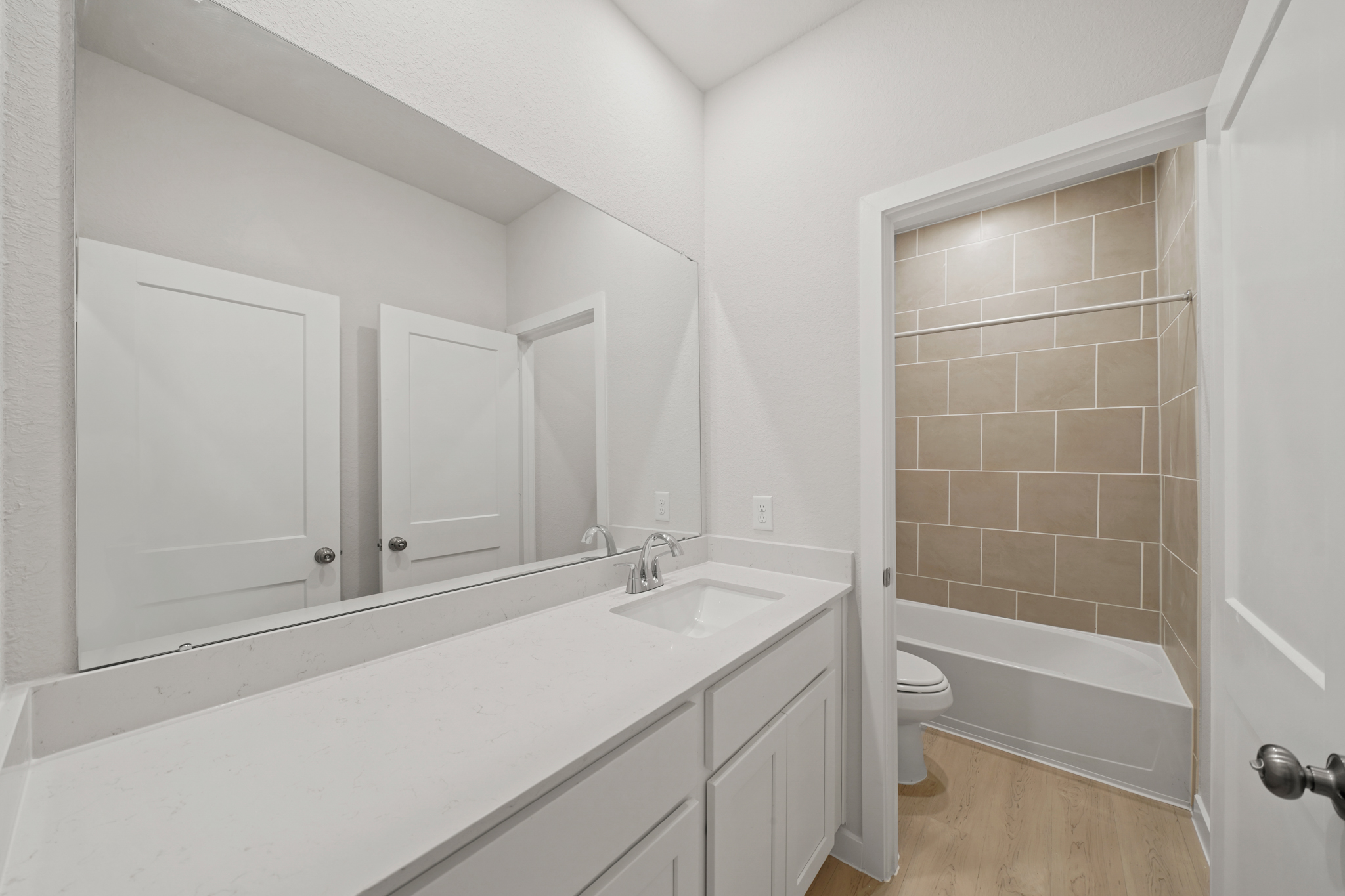 A bathroom with a tub sink and toilet.