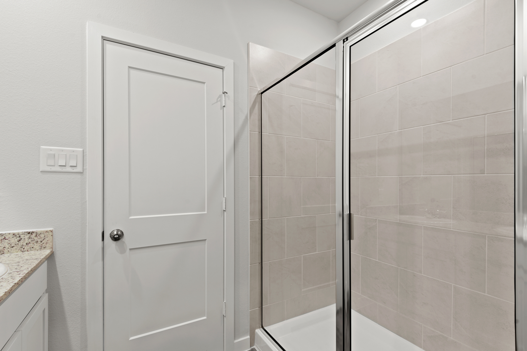 A bathroom with a glass shower.