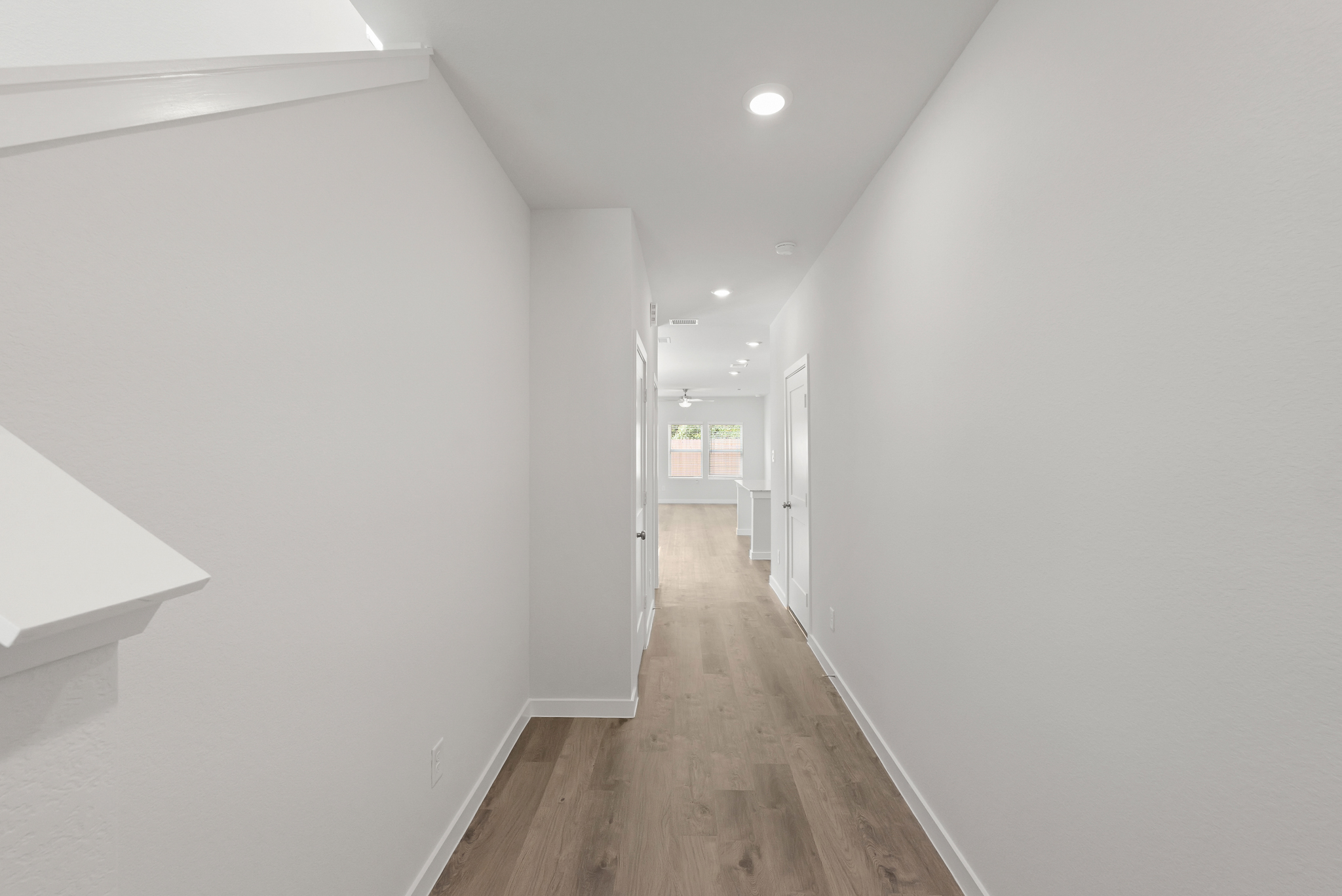 A long hallway with white walls.