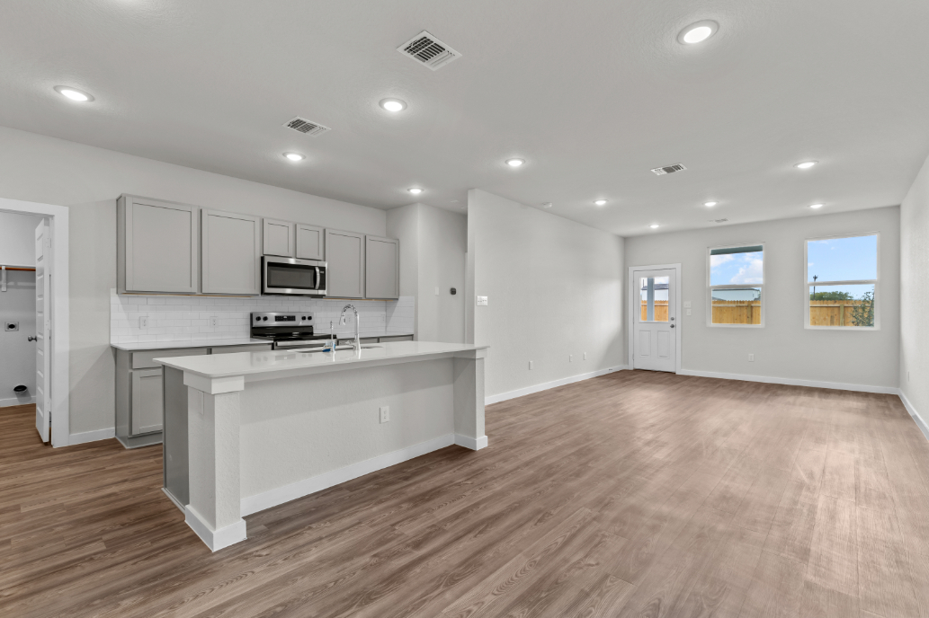 A kitchen with white cabinets.