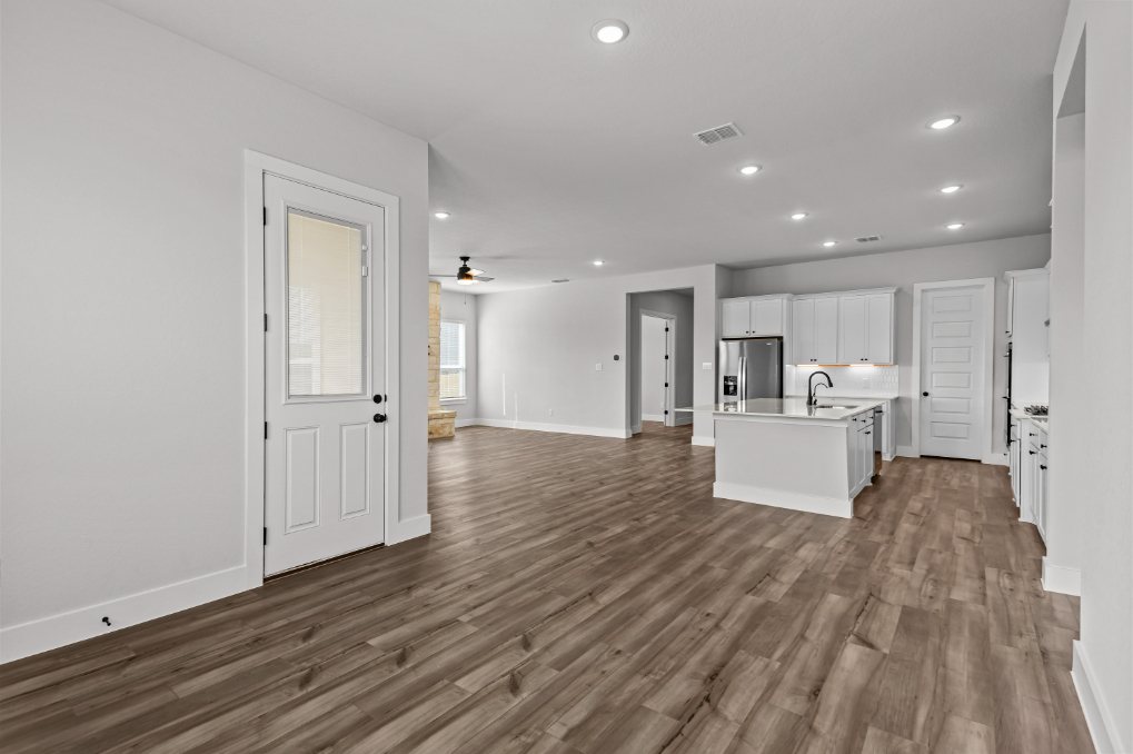 A large kitchen with white cabinets.