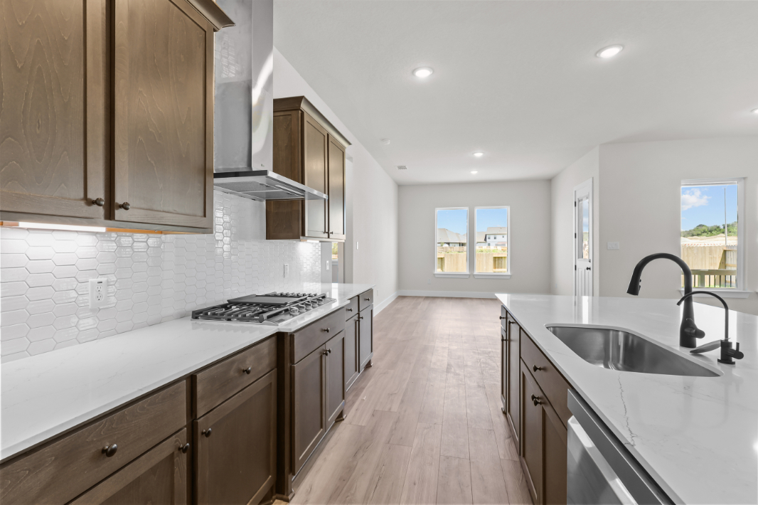 A kitchen with a wood floor.