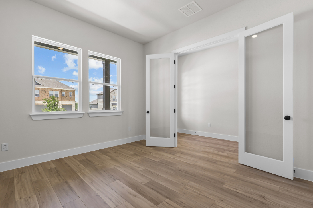 A room with white doors and a window.