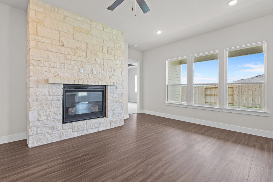 A room with a fireplace and a wood floor.
