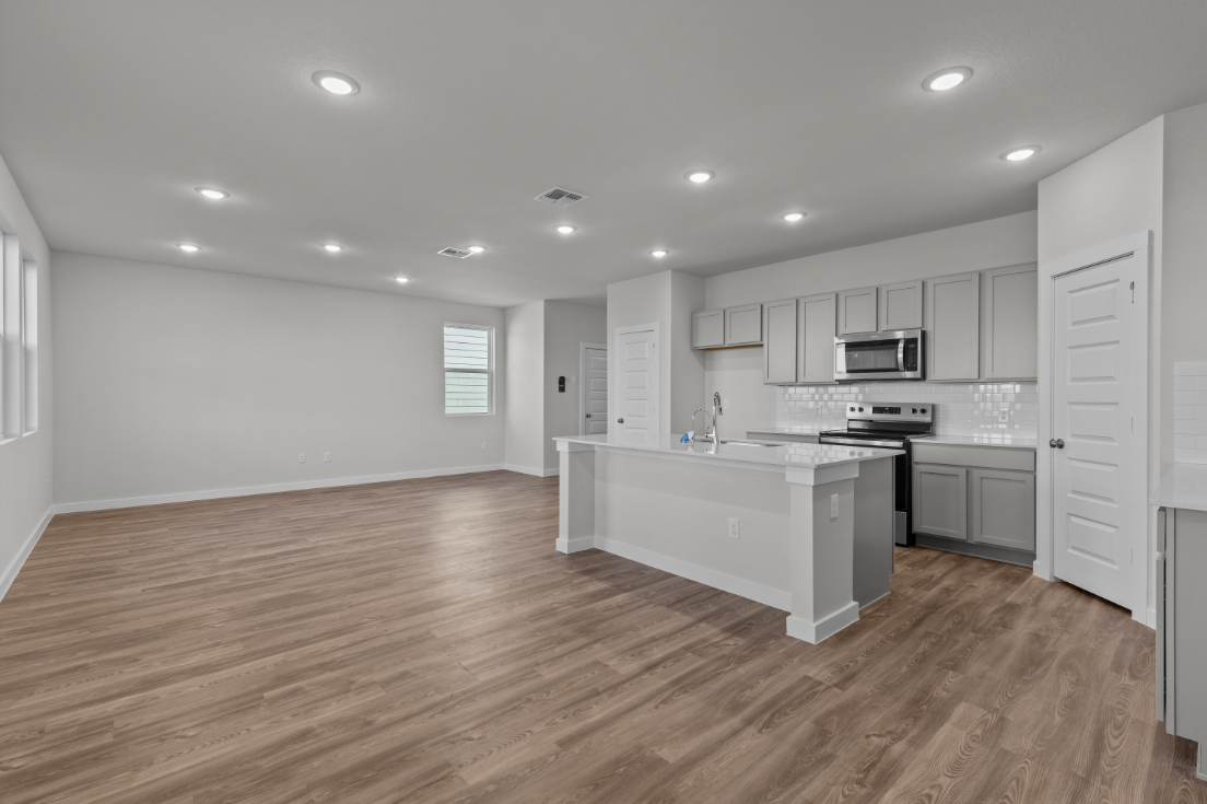 A kitchen with white cabinets.