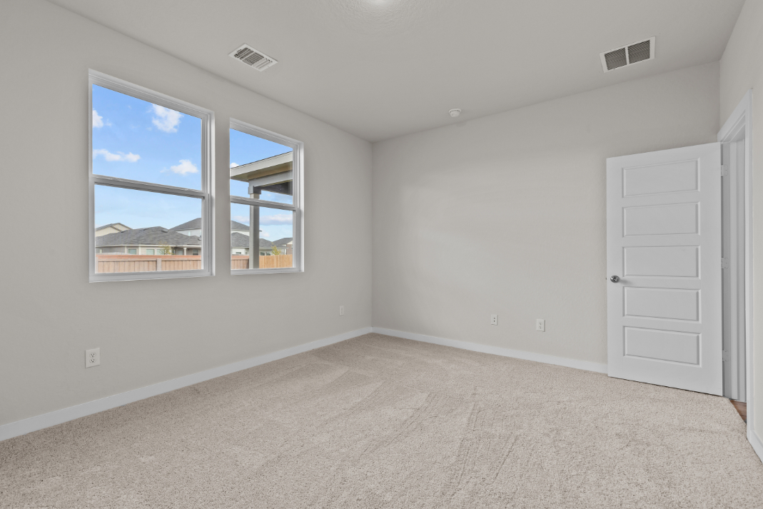 A room with a window and a door with a view of the city.