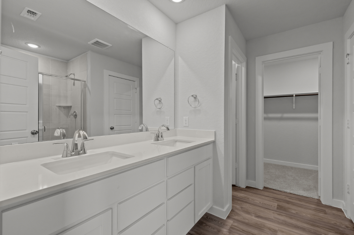 A bathroom with a large mirror.