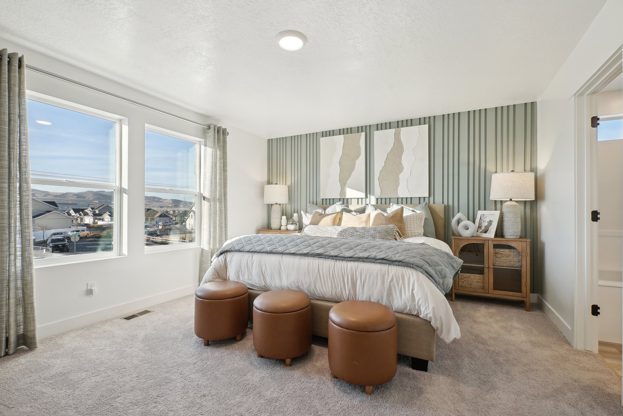 A bedroom with a large window.