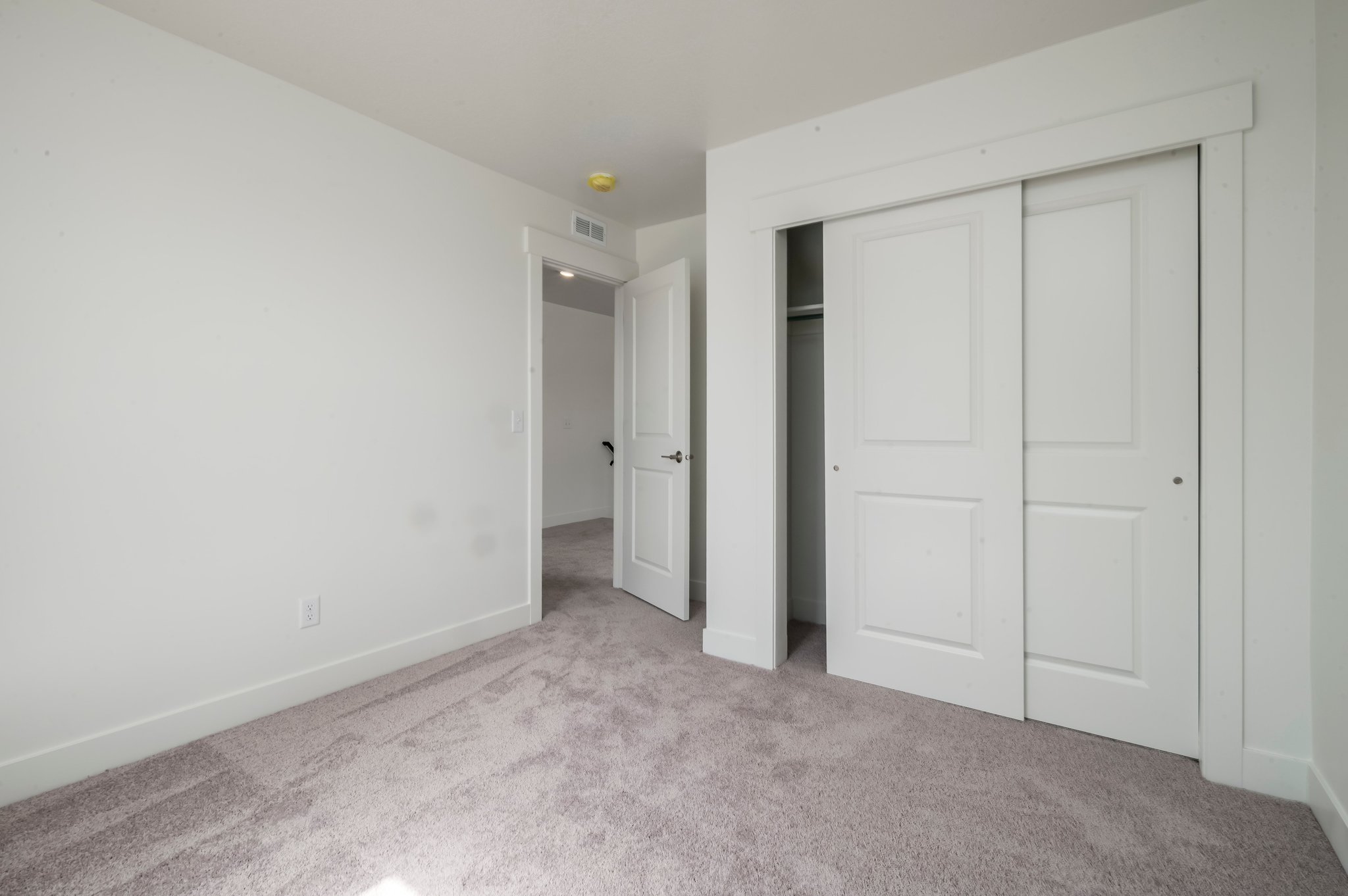 A hallway with white doors.