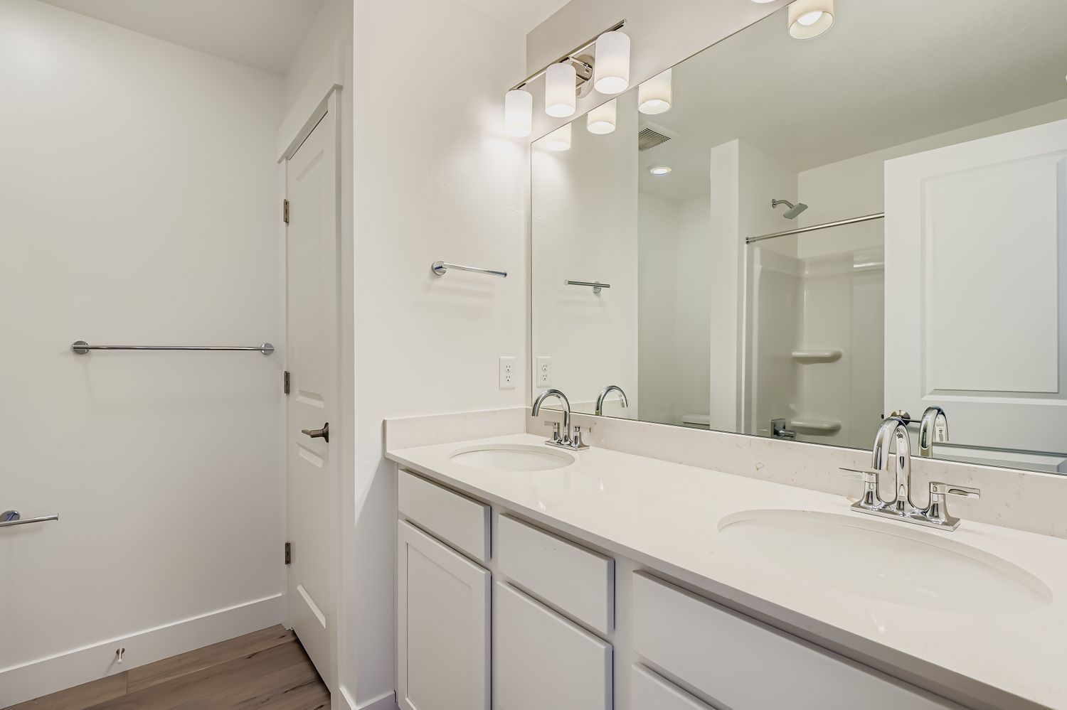 A bathroom with a large mirror.