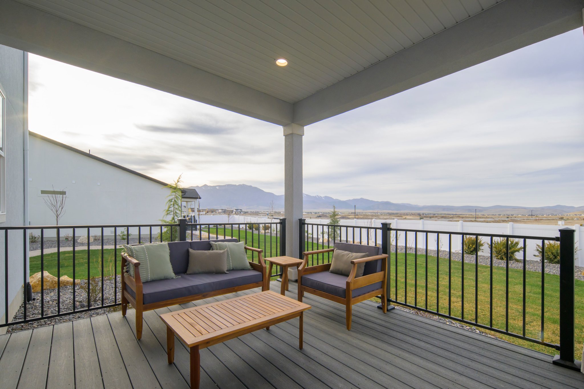 A deck with a bench and a table on it.