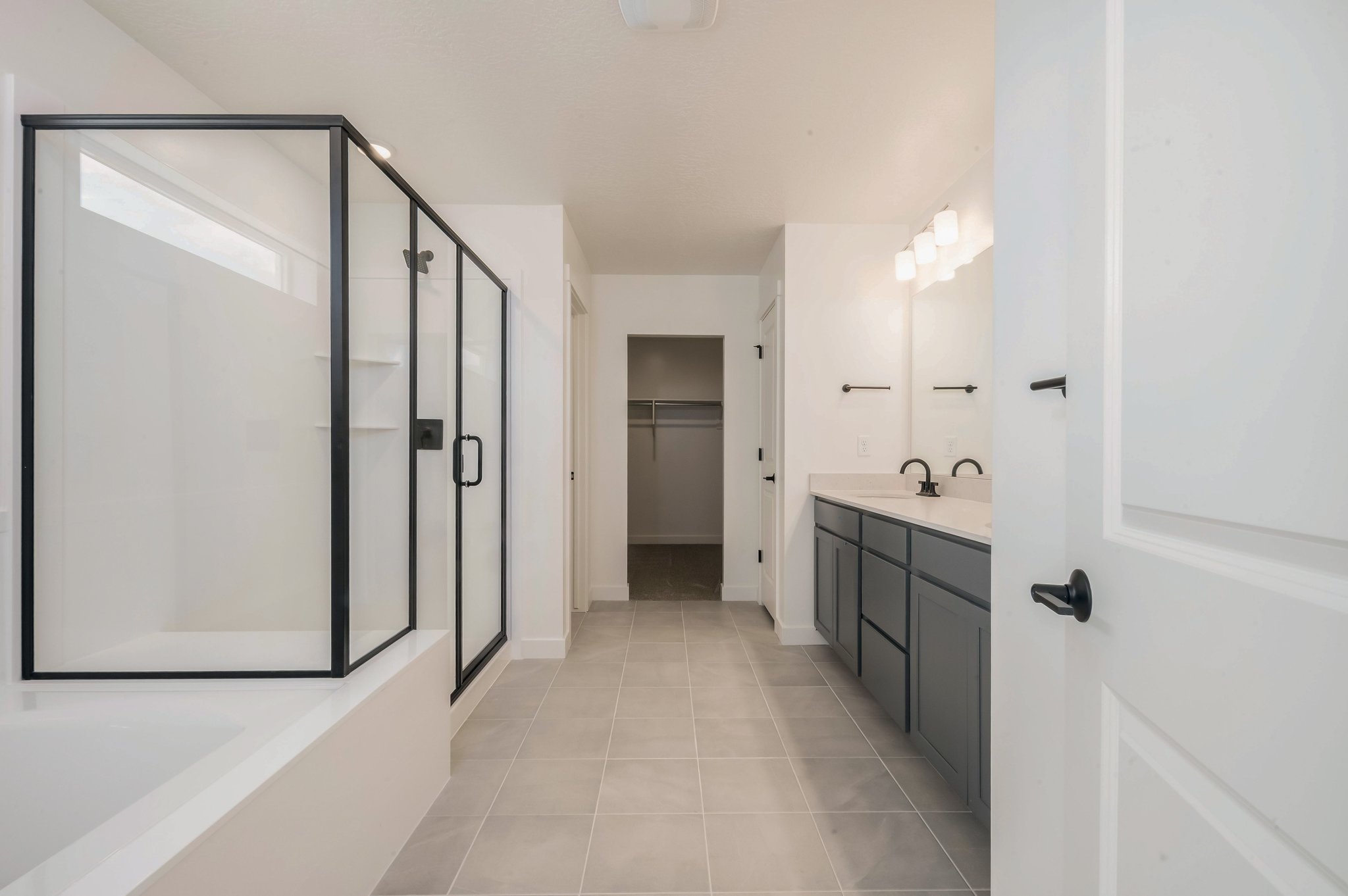 A bathroom with white cabinets.