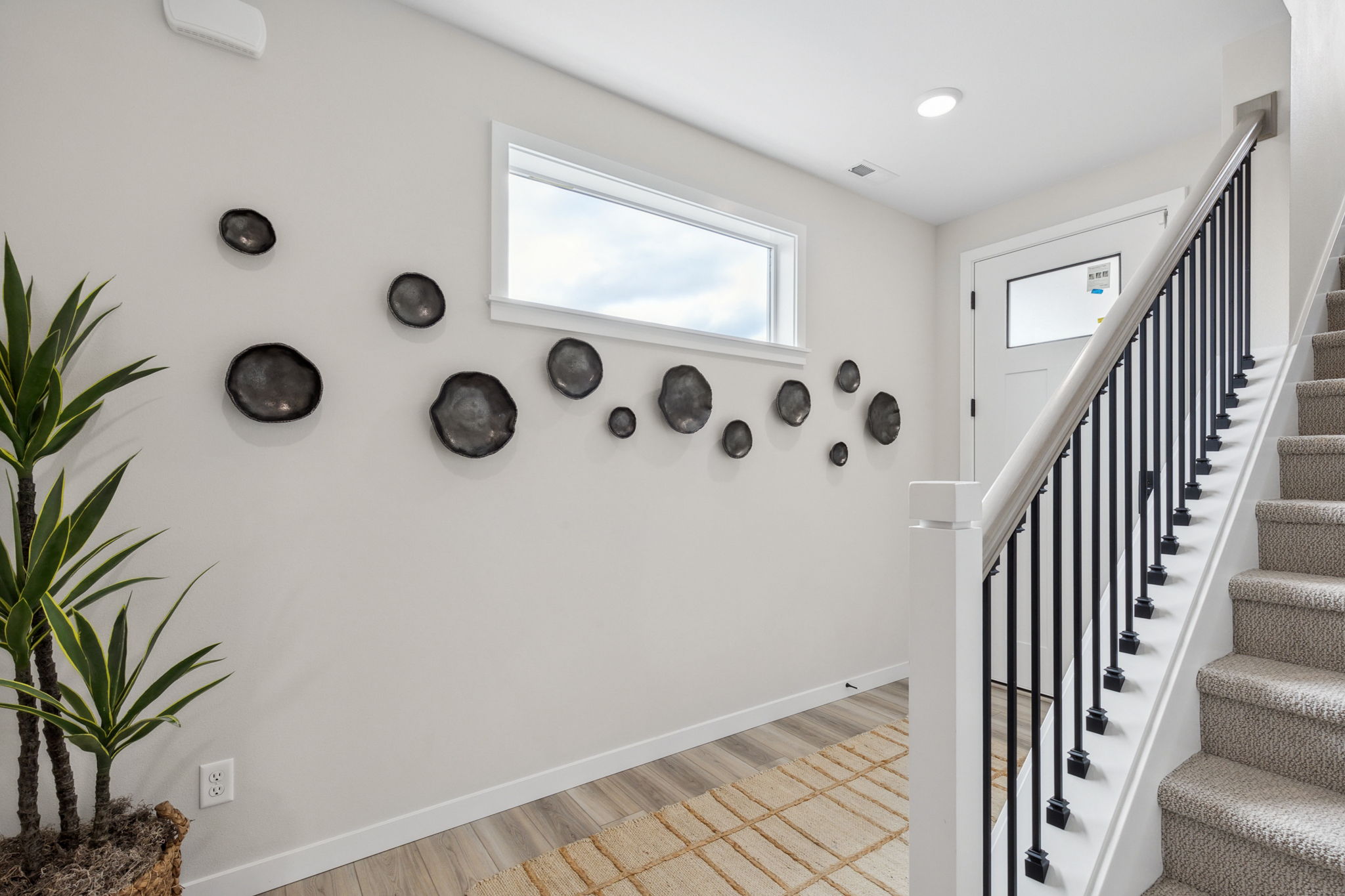 A staircase with a white wall.