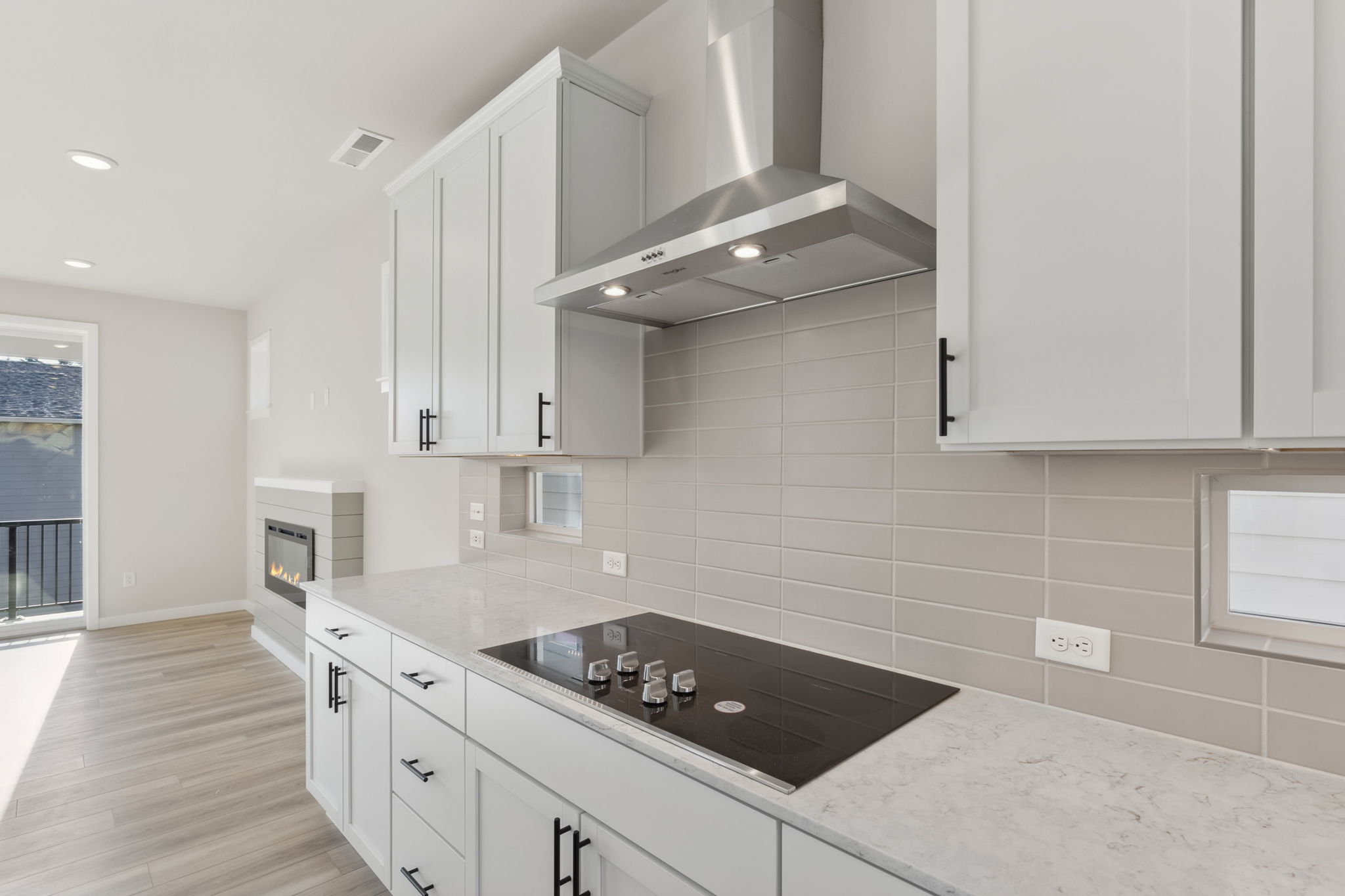 A kitchen with white cabinets.