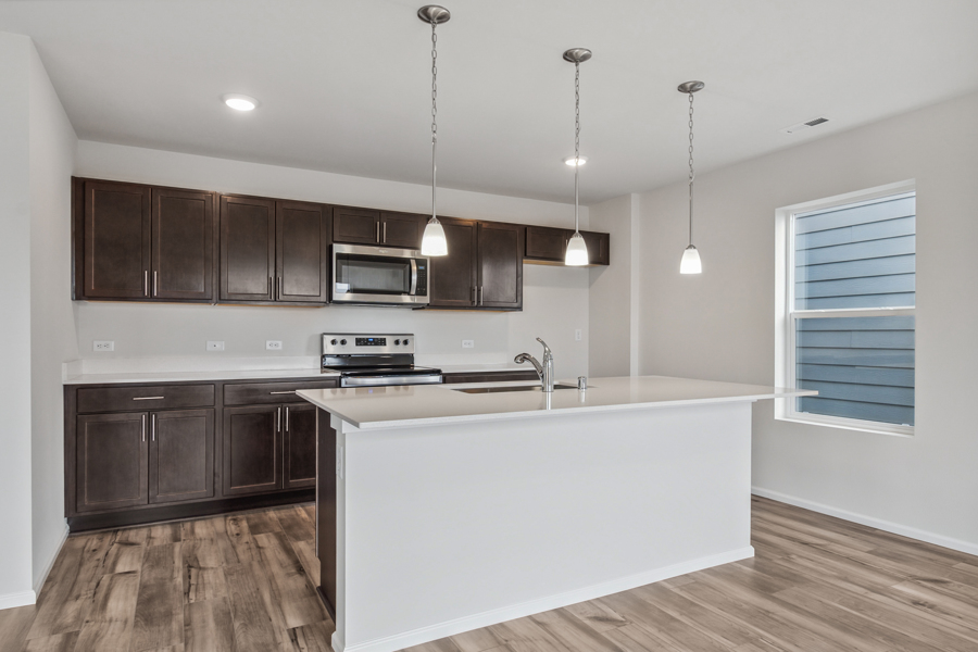 A kitchen with a white tub.
