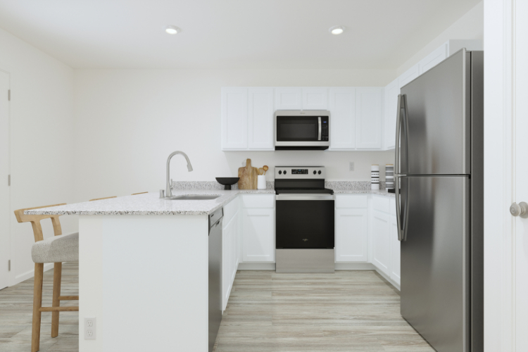 A kitchen with white cabinets.