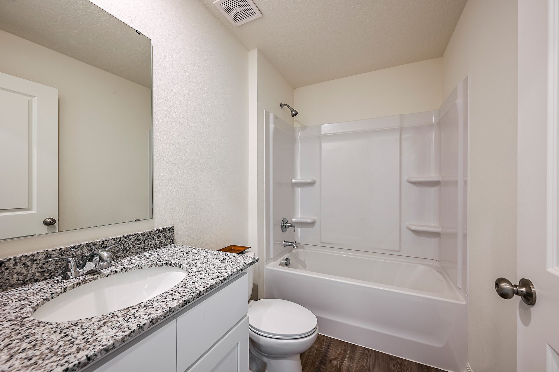 A bathroom with a marble countertop.
