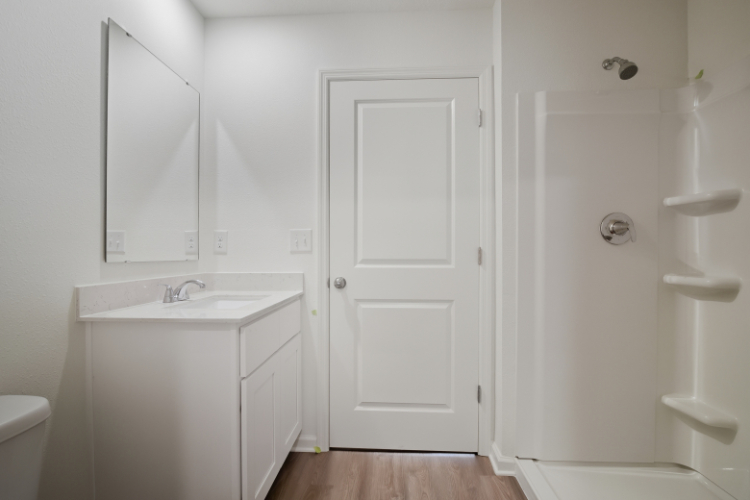 A bathroom with a sink and a mirror.