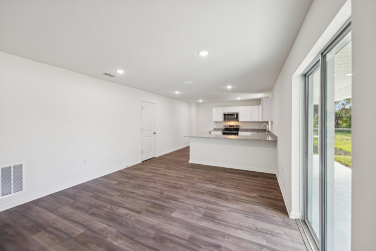 A room with a wood floor and white walls.