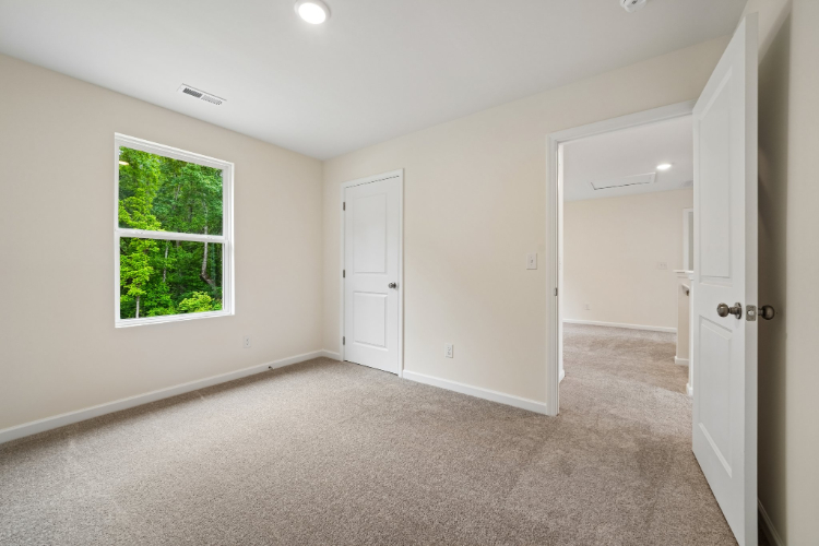 A room with white walls and a window.