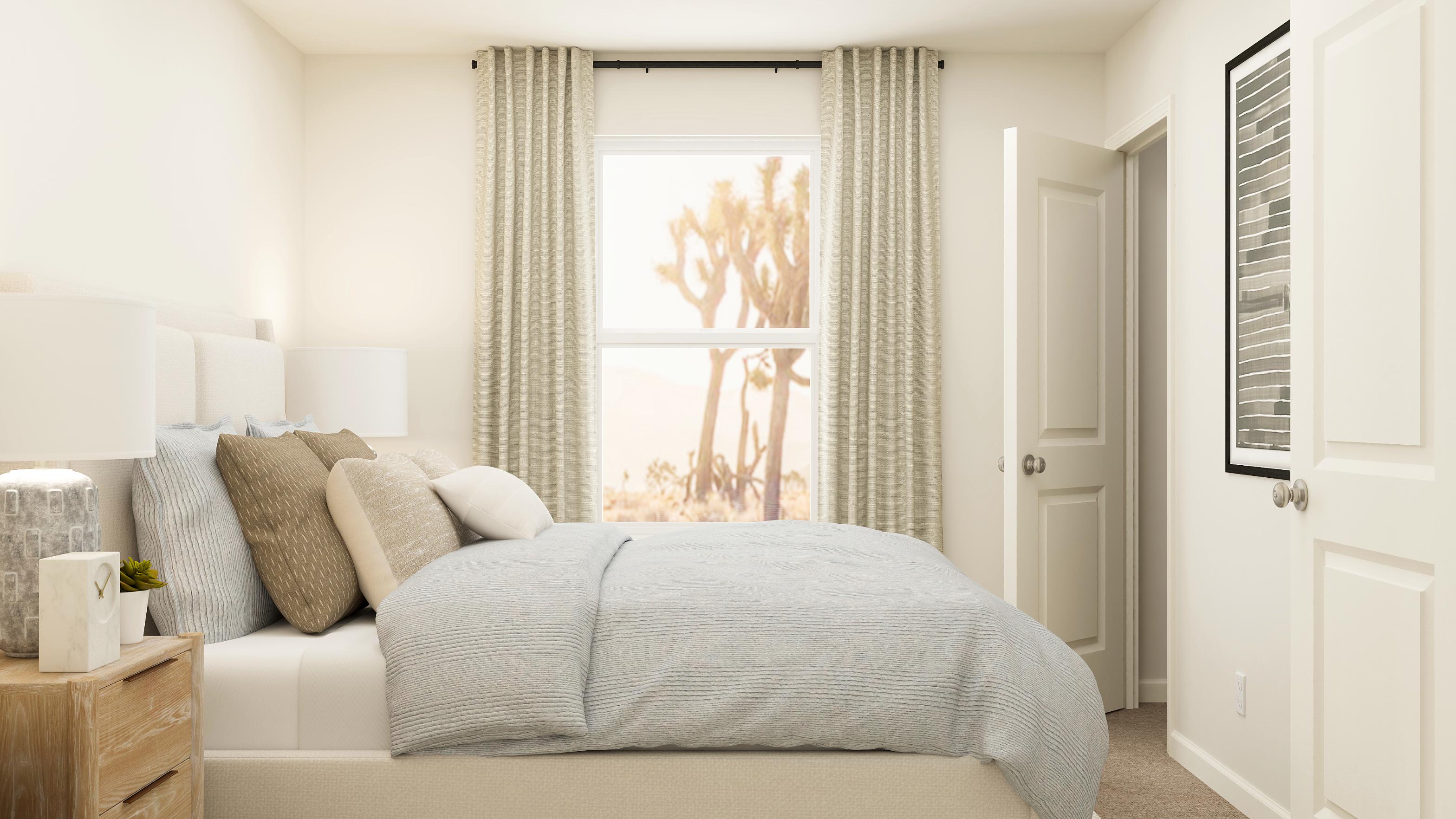 A bed with a white bed spread.