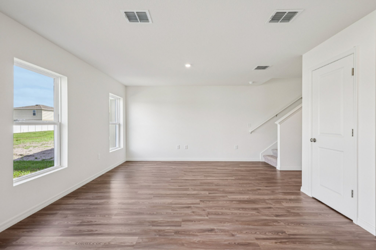 A room with white walls and a wood floor.