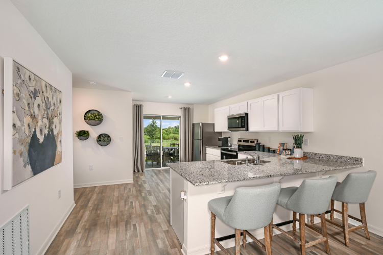 A kitchen with white cabinets.
