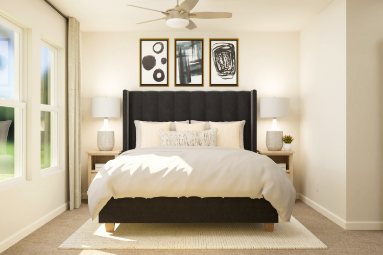 A bedroom with a bed and lamps.