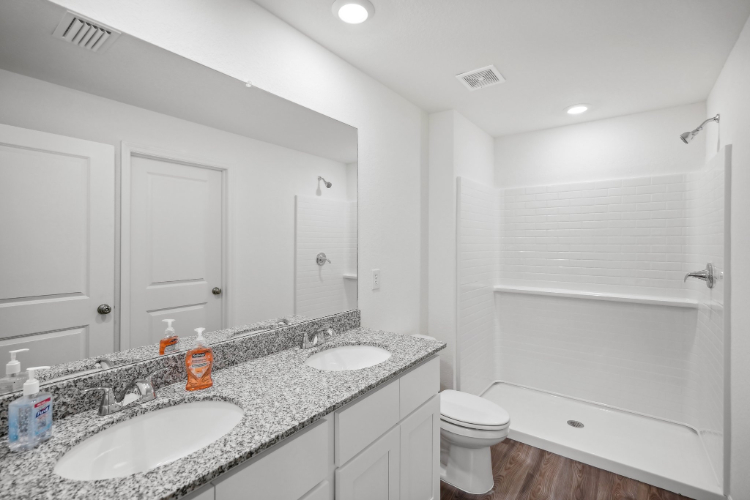 A bathroom with a sink toilet and shower.