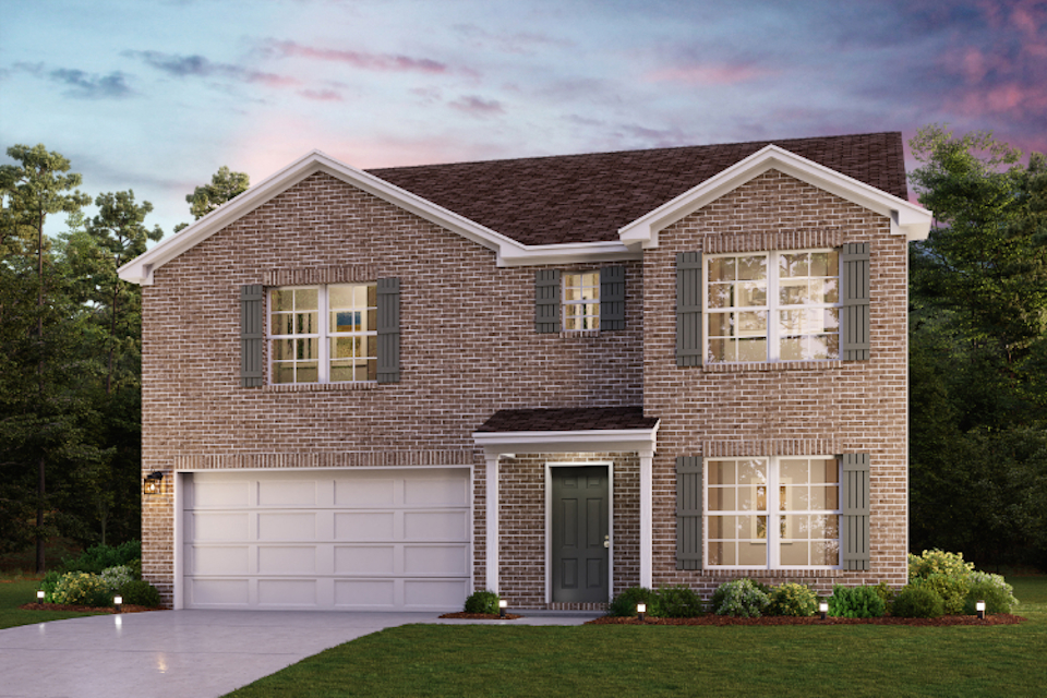 A brick house with a garage.